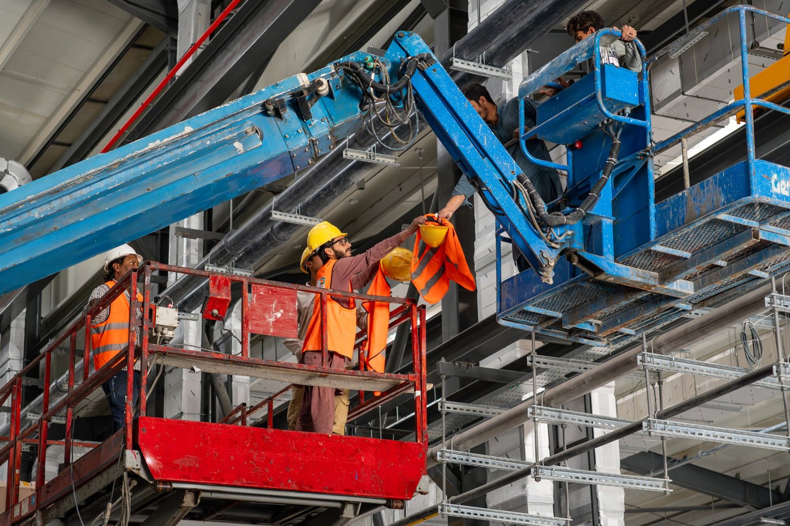 SEED crew installing services at height on a live production site